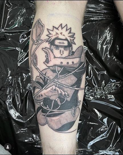 Black and grey anime piece on the forearm